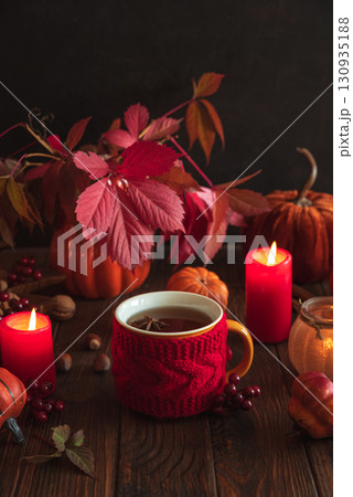 Cozy Autumn Scene with Mulled Wine, Candles, Pumpkins and Seasonal Decor Cozy Autumn Scene with Mulled Wine, Candles, Pumpkins and Seasonal Decor 130935188