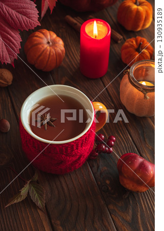 Cozy Autumn Scene with Mulled Wine, Candles, Pumpkins and Seasonal Decor Cozy Autumn Scene with Mulled Wine, Candles, Pumpkins and Seasonal Decor 130935189