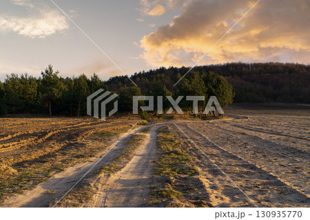 Pathway through a serene landscape showcasing sustainable land management practices 130935770