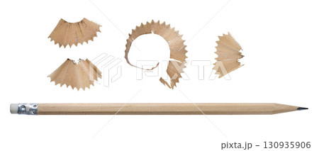 Close-up of wooden pencil with sharpened tip and shavings, isolated background Close-up of wooden pencil with sharpened tip and shavings, isolated background 130935906
