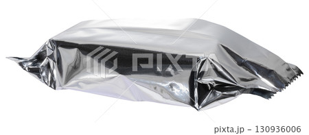 Crumpled silver foil packaging with torn edges, isolated background. Crumpled silver foil packaging with torn edges, isolated background. 130936006