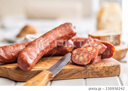 Sliced smoked sausage on cutting board. Sliced smoked sausage on cutting board. 130936242