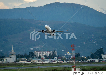 Airplane taking off from the airport, mountain on background. Airplane taking off from the airport, mountain on background. 130936563
