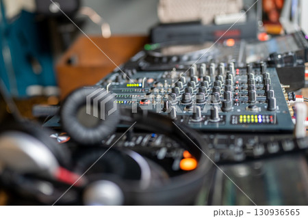 DJ console. Amplifying equipment, studio audio mixer knobs and faders. Music production, creation. 130936565
