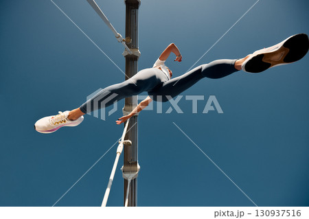 Dynamic low-angle shot of an athletic individual in focused running motion 130937516