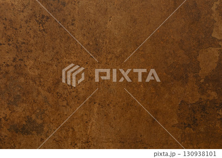 Textured brown surface with earthy tones showcasing natural imperfections and variation in hue and Textured brown surface with earthy tones showcasing natural imperfections and variation in hue and 130938101