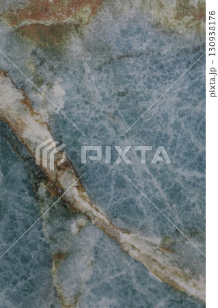 Natural stone surface featuring a stunning blue and white marble pattern with unique veins and 130938176