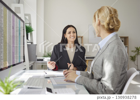 Happy Coworkers Handling Accounting In Office Meeting Happy Coworkers Handling Accounting In Office Meeting 130938278