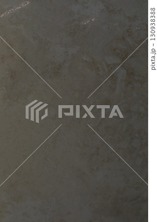 Textured surface showcases earthy tones and subtle variations in light and shadow 130938388