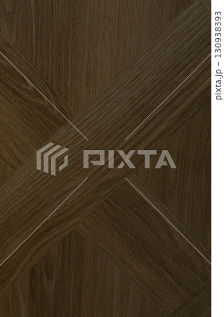 Wooden flooring with a crisscross pattern in a warm brown color creating an elegant interior Wooden flooring with a crisscross pattern in a warm brown color creating an elegant interior 130938393