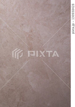 Close-up view of light-colored stone surface with unique patterns and textures in natural light 130938428