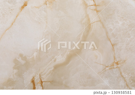 Elegant beige marble surface with delicate gold veins and a polished finish showcasing natural 130938581