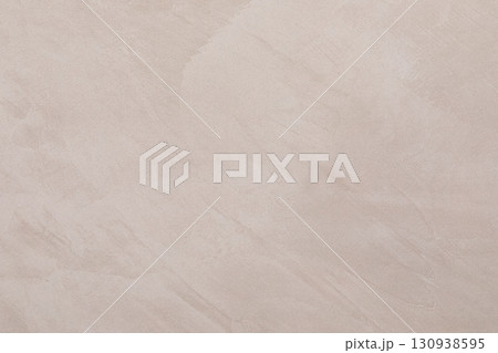Smooth beige plaster wall with subtle texture ideal for modern interior design projects 130938595