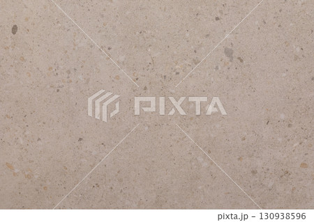 Light beige textured surface showcasing natural variations and small stones in a contemporary 130938596