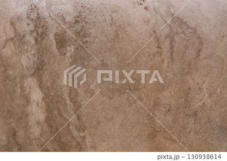 Natural textured stone surface with subtle patterns and earthy tones for modern interior design Natural textured stone surface with subtle patterns and earthy tones for modern interior design 130938614