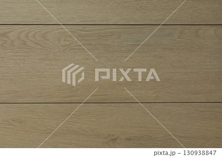 Natural light wood flooring with a smooth texture and warm tones in a cozy interior space 130938847