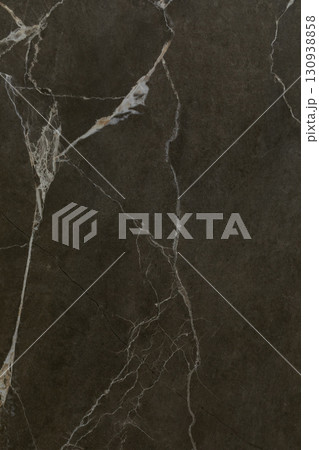 Dark marble surface with white veining showcasing a unique natural pattern and texture ideal for Dark marble surface with white veining showcasing a unique natural pattern and texture ideal for 130938858