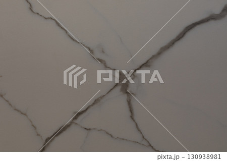 Elegant marble surface with intricate veins and natural patterns showcased in soft lighting Elegant marble surface with intricate veins and natural patterns showcased in soft lighting 130938981
