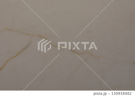 Natural marble surface with unique veining patterns showcasing subtle colors and textures in a close 130938982