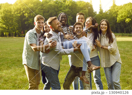 Multiracial group of cheerful best friends having fun together enjoying summer day in park. 130940126
