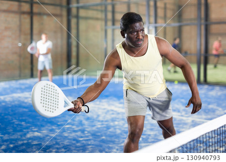 African american man playing paddle tennis African american man playing paddle tennis 130940793