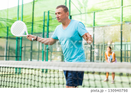 Male padel tennis player training on court Male padel tennis player training on court 130940798