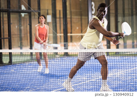African american man playing paddle tennis African american man playing paddle tennis 130940912