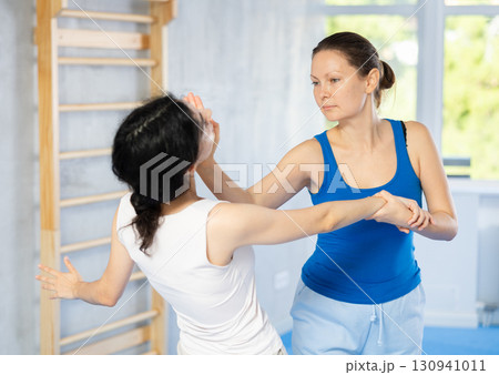 women trained in executing powerful palm punch 130941011