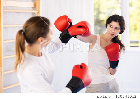 Two women training boxing fight in studio Two women training boxing fight in studio 130941012
