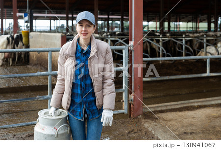 Portraif of woman dairy farm worker with milk can Portraif of woman dairy farm worker with milk can 130941067
