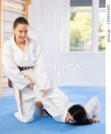 Two women training judo techniques in studio Two women training judo techniques in studio 130941080