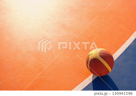 Basketball on the orange court for sport advertisement. 130941596