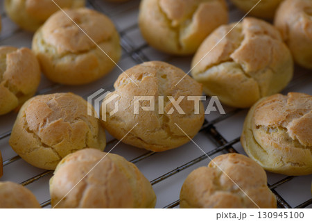 Delicious golden pastry balls cooling on a wire rack in a cozy kitchen setting 130945100