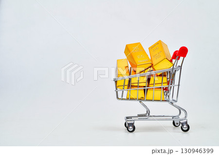 Gold bars in shopping cart isolated on white background Gold price rising all time high, high demand purchasing Gold bars in shopping cart isolated on white background Gold price rising all time high, high demand purchasing 130946399
