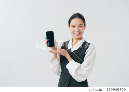スマホを持つ女性スタッフ スマホを持つ女性スタッフ 130946790