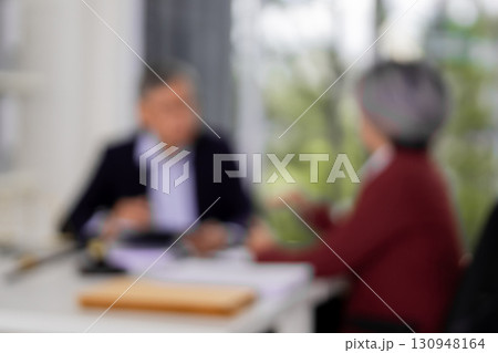 Asian adult lawyer professional client discuss legal consultation business strategy resolving dispute reviewing documents at law office formal setting Asian adult lawyer professional client discuss legal consultation business strategy resolving dispute reviewing documents at law office formal setting 130948164
