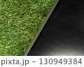 Modern black solar panel placed on green grass 130949384