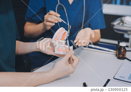 dentist consultation - patient visit at dental clinics office 130950125