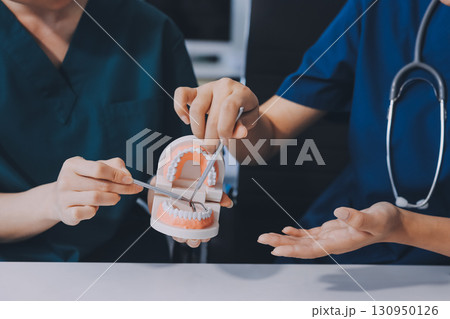 dentist consultation - patient visit at dental clinics office 130950126