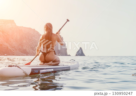 Woman Paddleboarding Sea Cliffs Summer 130950247