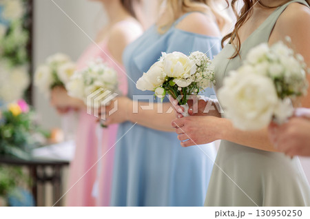 Bridesmaids carrying elegant white peony bouquets, highlighting wedding ceremony's elegance floral and romantic moments Bridesmaids carrying elegant white peony bouquets, highlighting wedding ceremony's elegance floral and romantic moments 130950250