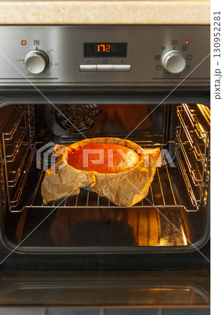 Cooking process homemade Basque burnt cheesecake. Ready toasted cheesecake is in the oven. Recipe step by step 130952281