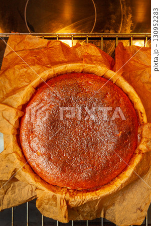Homemade Basque burnt cheesecake immediately after baking on a rack 130952283