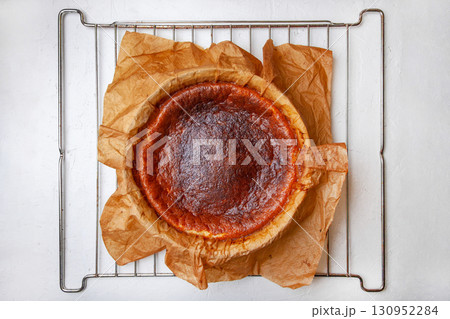 Homemade Basque burnt cheesecake immediately after baking on a rack 130952284