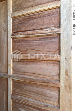 Rustic wooden door panel with natural grain texture 130952958