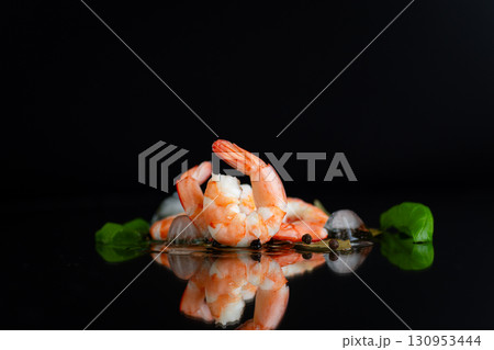 Appetizing shrimp with spices on a black background studio 130953444