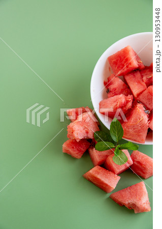 bright watermelon slices in bowl and on surface bright watermelon slices in bowl and on surface 130953448