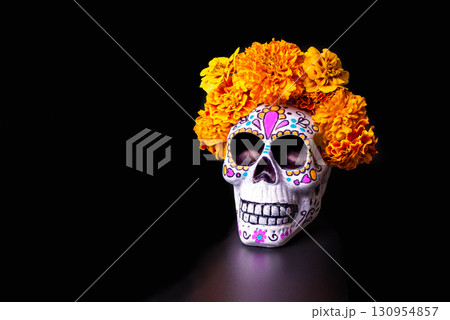 Painted skull with orange marigold flowers. Dia De Los Muertos holiday. Painted skull with orange marigold flowers. Dia De Los Muertos holiday. 130954857