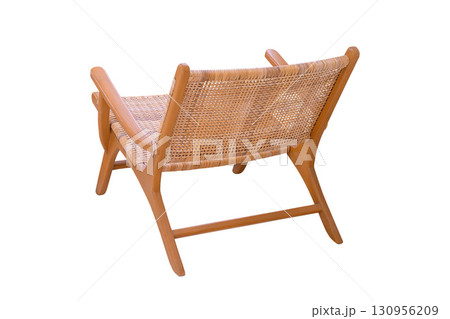 Wooden chair covered with rattan isolated on white background. View from the side offset to the back Wooden chair covered with rattan isolated on white background. View from the side offset to the back 130956209