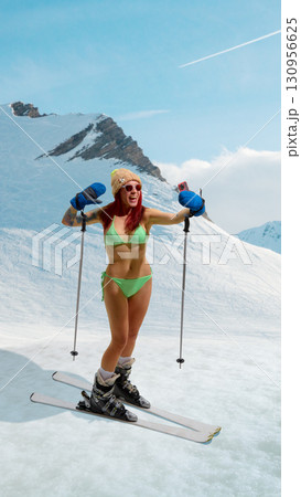 Female skier in bikini raising arms in joy on snowy mountain with bright emotion. Hand made collage 130956625